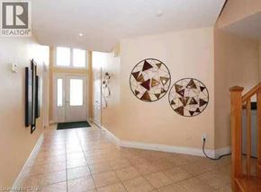 Waterloo apartment for rent - A hallway with a tiled floor and two circular artworks on the wall.