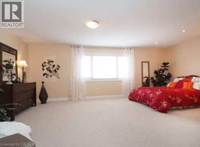 Waterloo apartment for rent - A bedroom with a red bedspread and a Christmas tree.