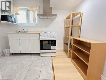 Waterloo apartment for rent - A kitchen with a white cabinet and a white stove top oven.