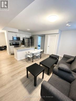 Barrie (Georgian Drive) townhouse for rent - A living room with a grey couch and a black coffee table.