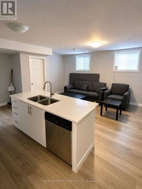 Barrie (Georgian Drive) townhouse for rent - A kitchen with white cabinets and a black dishwasher.