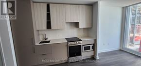 Mississauga (City Centre) condo for rent - A modern kitchen with a stove top oven and a sink.