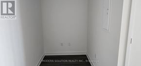 Mississauga (City Centre) condo for rent - A white room with a brokerage sign on the wall.