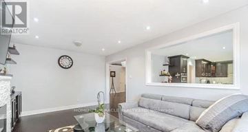 Brampton (Northwood Park) apartment for rent - A living room with a grey sofa and a glass coffee table.