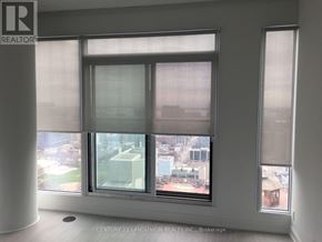 Toronto (Moss Park) condo for rent - A window with a view of a cityscape is the focal point of the image.