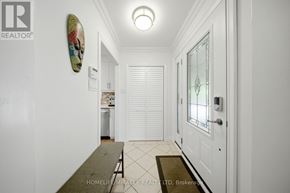 Mississauga (Applewood) apartment for rent - A hallway with a white door and a framed picture on the wall.