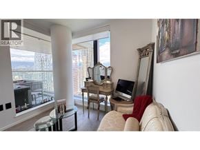 Vancouver apartment for rent - A living room with a couch, chair, and a desk with a computer.