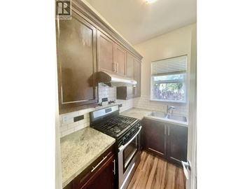 Coquitlam apartment for rent - A kitchen with a stove top oven and a sink.