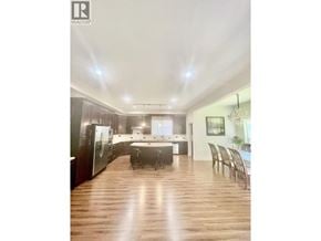 Coquitlam apartment for rent - A well-lit kitchen with wooden floors and modern appliances.