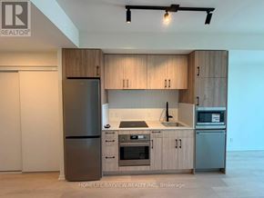 Toronto (Mount Pleasant West) condo for rent - A modern kitchen with wooden cabinets and stainless steel appliances.