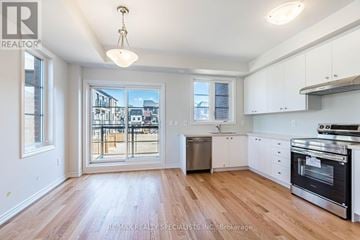 Mississauga (East Credit) townhouse for rent - A kitchen with white cabinets and a wooden floor.