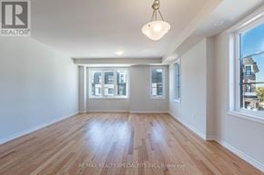 Mississauga (East Credit) townhouse for rent - A room with wooden floors and a large window.