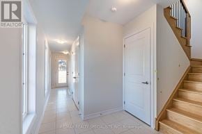 Mississauga (East Credit) townhouse for rent - A hallway with a staircase on the right and a door at the end.