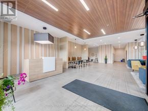 Kitchener condo for rent - A modern office lobby with a reception desk and seating area.