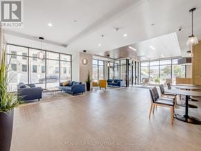 Kitchener condo for rent - A spacious living room with a large window and a view of the city.