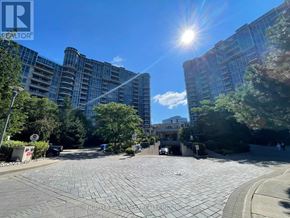Markham (Unionville) condo for rent - A sunny day in a residential area with modern buildings and a paved walkway.