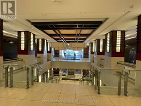 Markham (Unionville) condo for rent - A spacious interior of a building with a glass railing and a tiled floor.