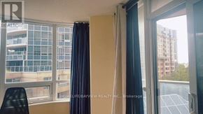 Markham (Unionville) condo for rent - A room with a window overlooking a building with a sign that says "REALTOR".