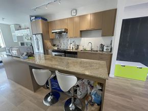 Surrey townhouse for rent - A kitchen with a counter and two chairs.