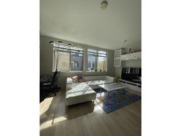 Surrey townhouse for rent - A living room with a white couch and a large window.