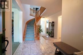 Mississauga (Central Erin Mills) apartment for rent - A hallway with a staircase and a bench.
