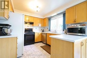 Mississauga (Central Erin Mills) apartment for rent - A kitchen with wooden cabinets and appliances.