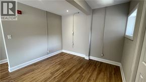 Hamilton apartment for rent - A room with wooden flooring and a sliding door.