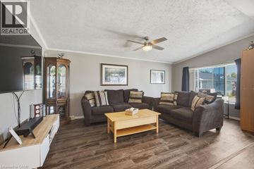 Puslinch apartment for rent - A living room with a brown couch and a wooden coffee table.