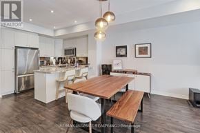 Toronto (Long Branch) townhouse for rent - A modern kitchen with a wooden table and chairs.