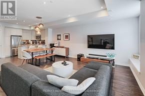 Toronto (Long Branch) townhouse for rent - A living room with grey couches and a television.