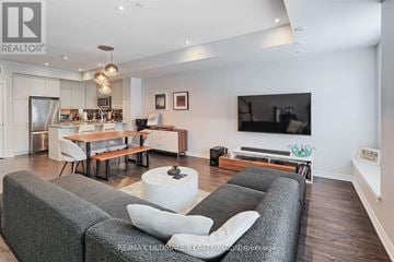 Toronto (Long Branch) townhouse for rent - A living room with grey couches and a television.