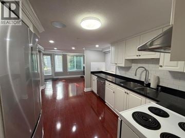 Vancouver apartment for rent - A kitchen with a stove and a refrigerator.