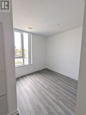 Toronto (Downsview-Roding-Cfb) condo for rent - A room with a window and wooden flooring.