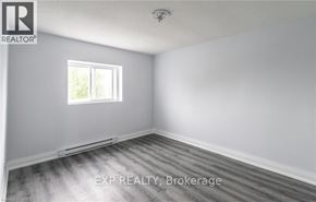 Port Colborne (Main Street) apartment for rent - A room with a window and wooden flooring.