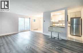 Port Colborne (Main Street) apartment for rent - A spacious room with a kitchenette in the background.