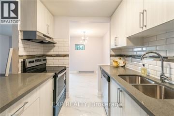 Port Colborne (Main Street) apartment for rent - A modern kitchen with white cabinets and stainless steel appliances.