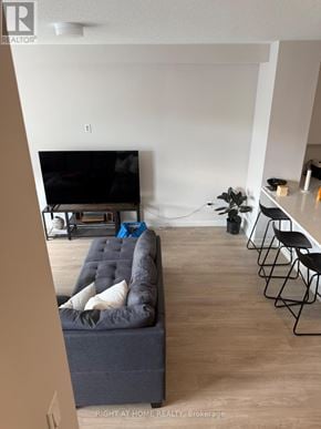 Ottawa townhouse for rent - A living room with a grey couch and a television.