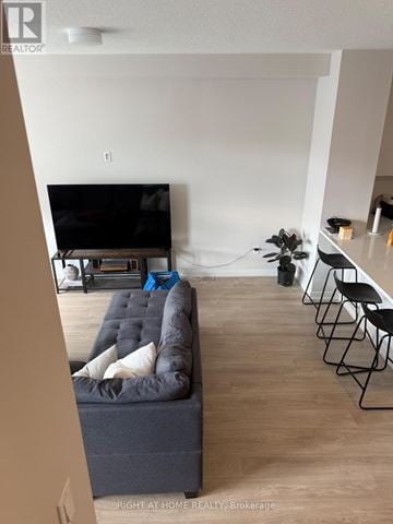 Ottawa townhouse for rent - A living room with a grey couch and a television.