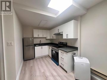 Toronto (Playter Estates-Danforth) apartment for rent - A kitchen with white cabinets and a stainless steel refrigerator.