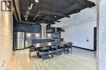 Guelph condo for rent - A modern kitchen with a dining table and chairs.