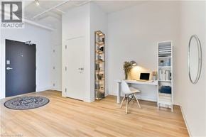 Guelph condo for rent - A room with a desk, chair, and shelves.