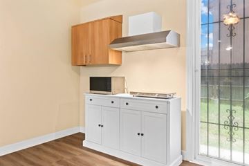 Manteca apartment for rent - A kitchen with a white cabinet and a stove top oven.