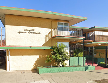 Oakland apartment for rent - A building with a balcony and a tree in front of it.