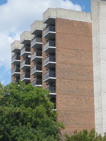 Ottawa apartment for rent - A tall building with a red brick facade and balconies.