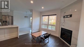 Richmond Hill (Westbrook) apartment for rent - A living room with a fireplace and a table with two chairs.