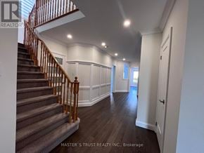 Richmond Hill (Westbrook) apartment for rent - A staircase with a wooden handrail and a carpeted runner leads to a landing with a door and a window.