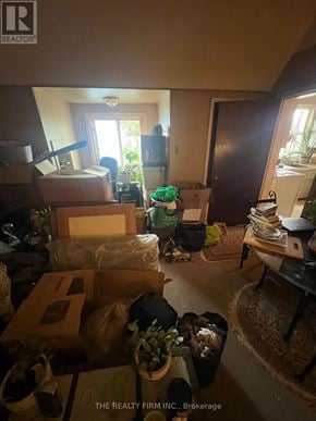 London East (East F) fourplex for rent - A room with boxes and furniture scattered around.