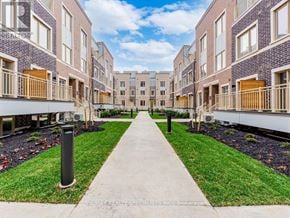 Vaughan (Vaughan Corporate Centre) townhouse for rent - A long concrete walkway leads between two rows of new townhouses.