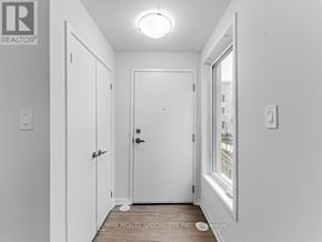 Vaughan (Vaughan Corporate Centre) townhouse for rent - A white door is in the middle of a hallway.