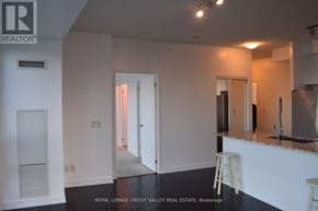 Mississauga (City Centre) condo for rent - A white room with a bar and a stool.
